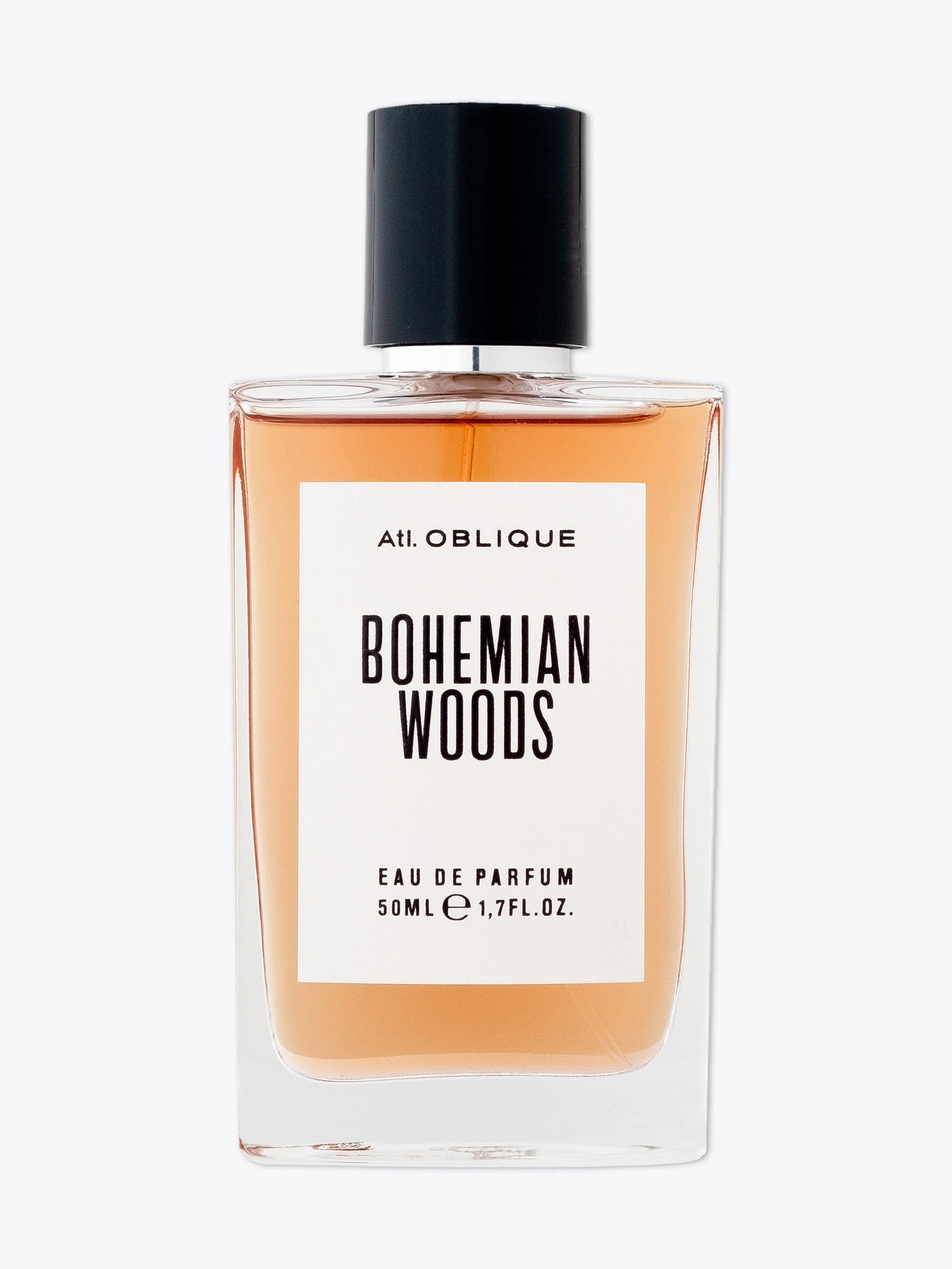 Atl. Oblique Bohemian Woods EDP 50ml bottle displaying its elegant design and label, surrounded by elements representing its leather-woody and spicy notes.